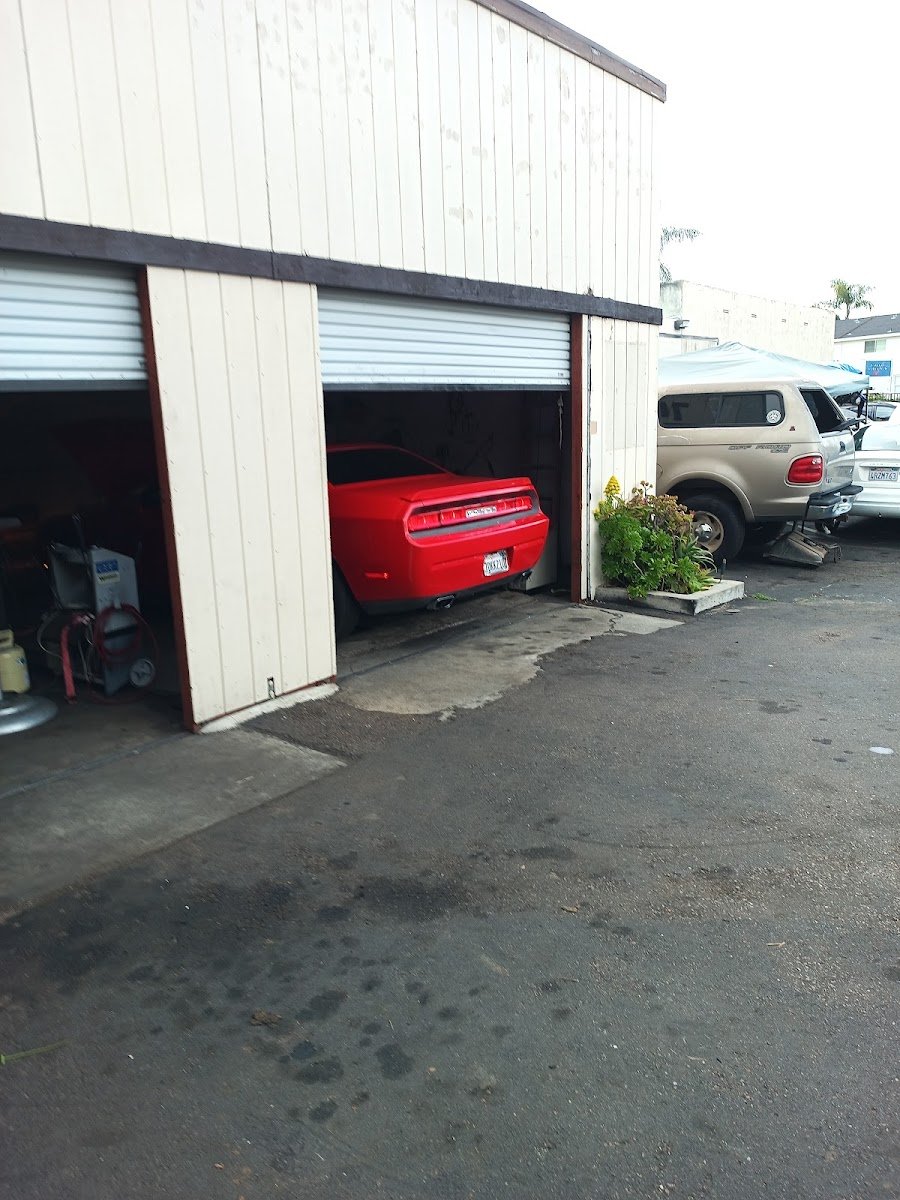 Open bay with a red car and smog equipment