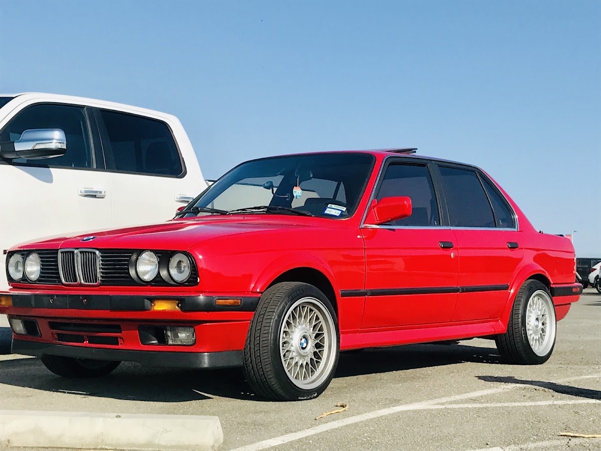 A red BMW sedan in the Speedy Smog lot