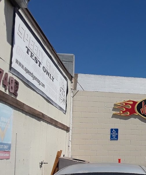 Speedy Smog Test Only banner and address 7482 on the building